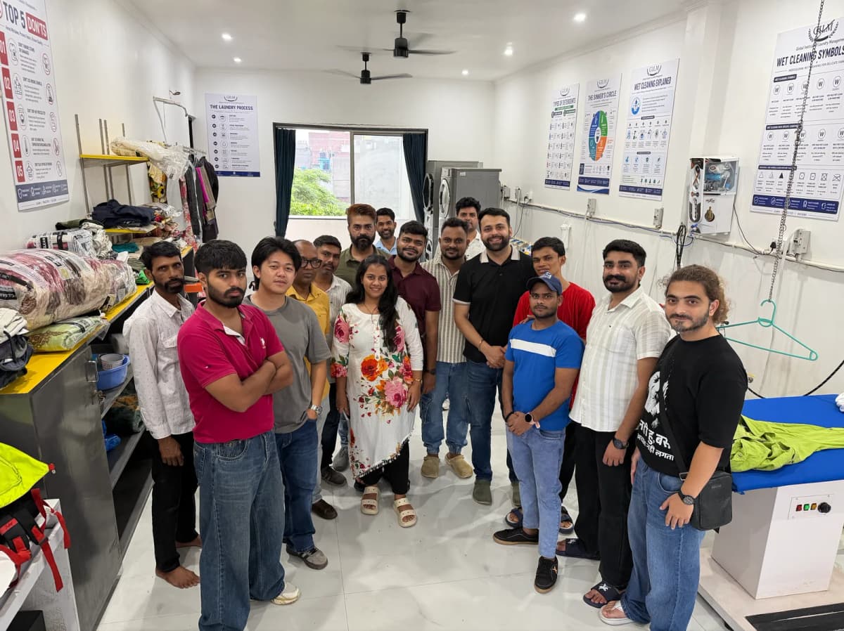 Students learning at a practical laundry and dry cleaning training session